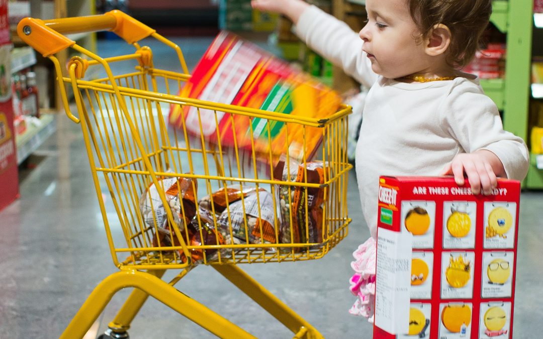 Baby-putting-shopping-items-into-cart